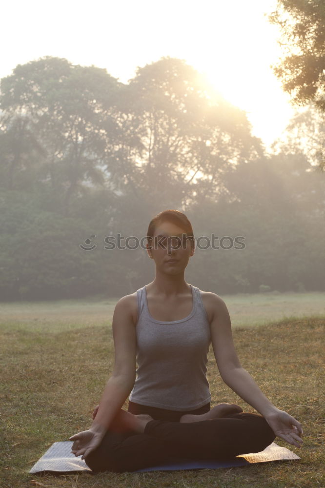 Similar – Young woman meditates in yoga asana Padmasana