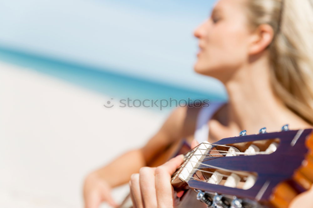 Similar – Beautiful woman playing guitar.