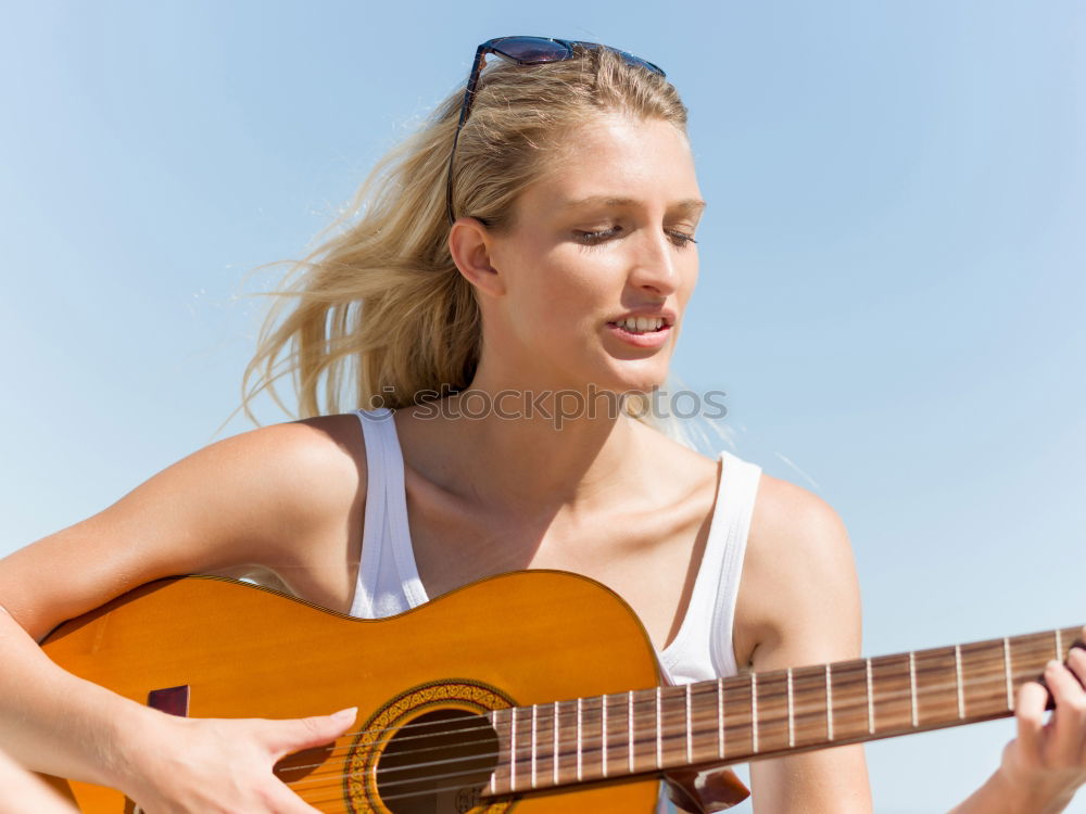 Similar – Beautiful woman playing guitar.