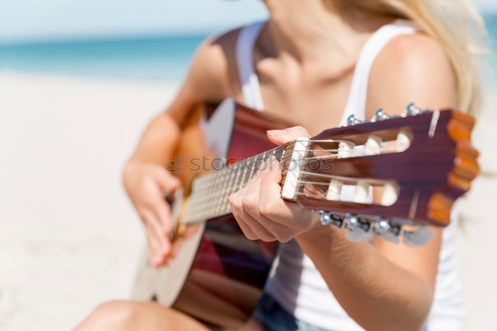 Beautiful woman playing guitar.