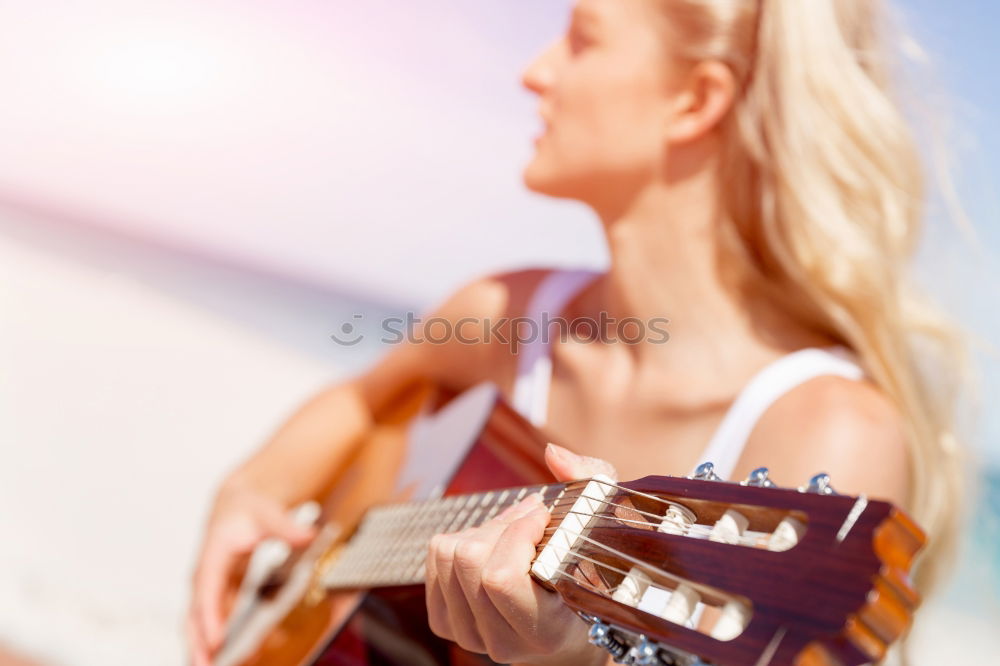 Similar – Beautiful woman playing guitar.