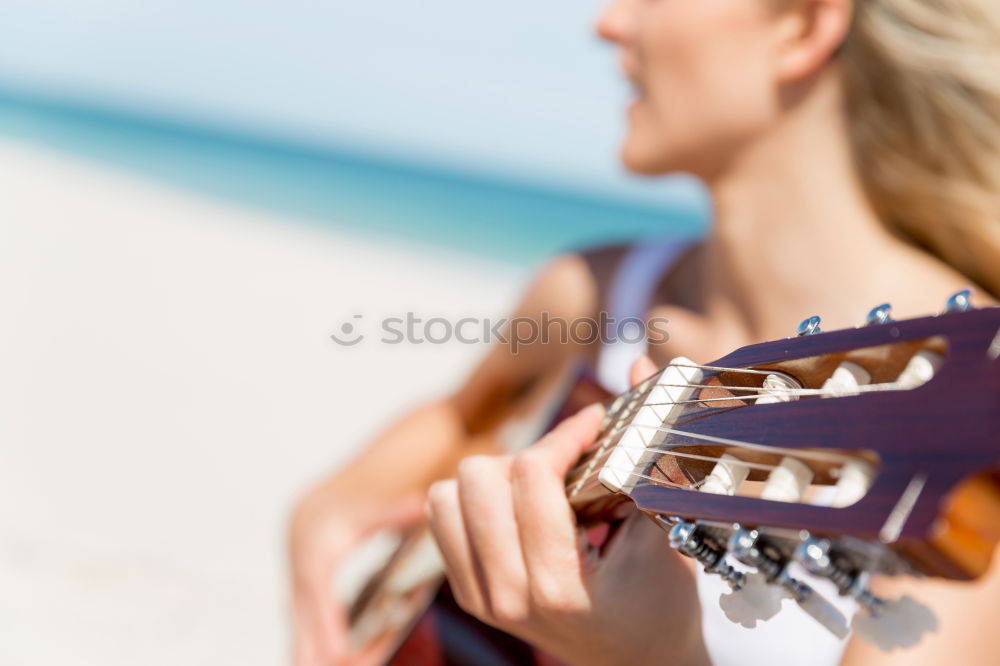 Similar – Beautiful woman playing guitar.