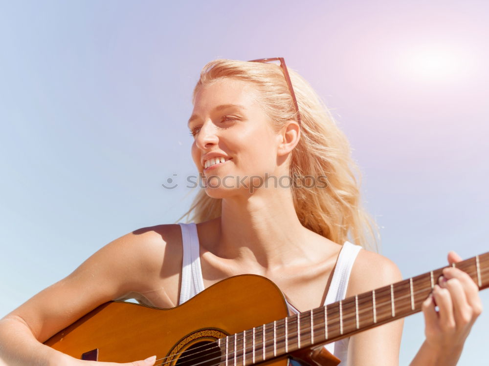 Beautiful woman playing guitar.