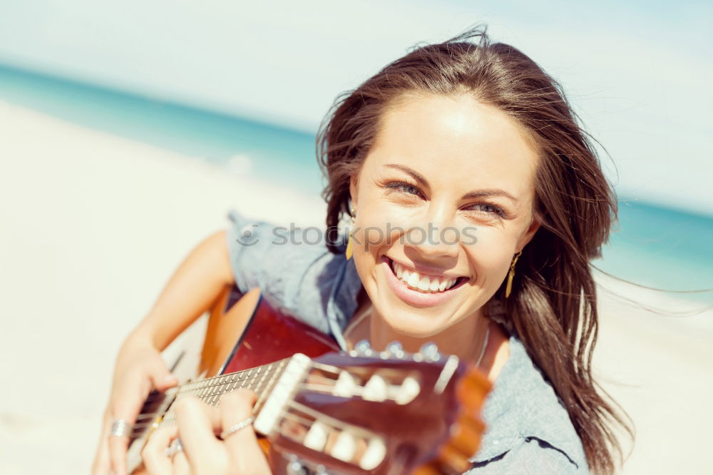 Similar – Beautiful woman playing guitar.