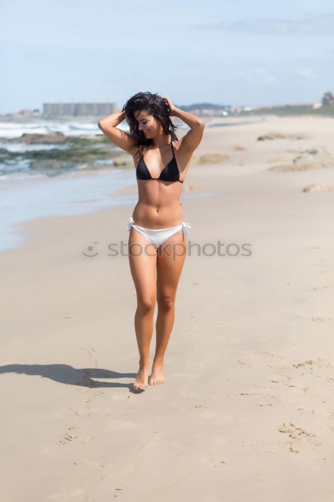 Similar – Image, Stock Photo Beautiful young woman posing on the sand in the beach