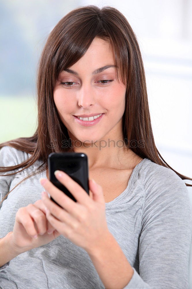 Similar – Young woman texting with a smartphone outdoors