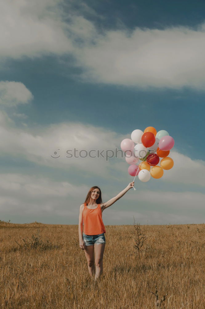 Woman throwing up hat in nature