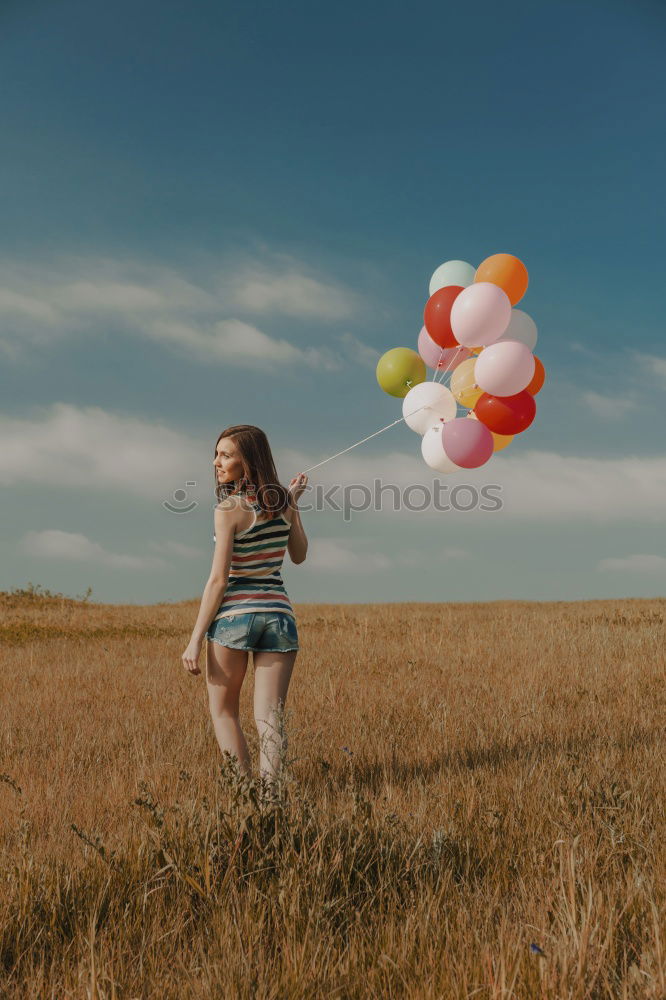 Similar – Woman throwing up hat in nature