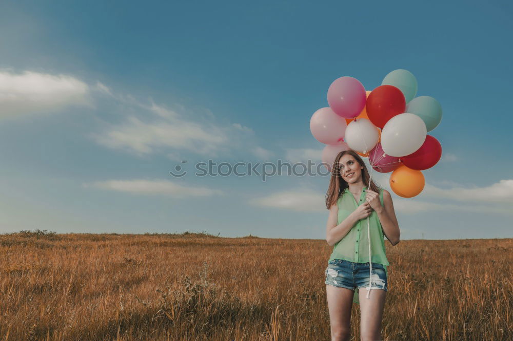 Similar – Woman throwing up hat in nature