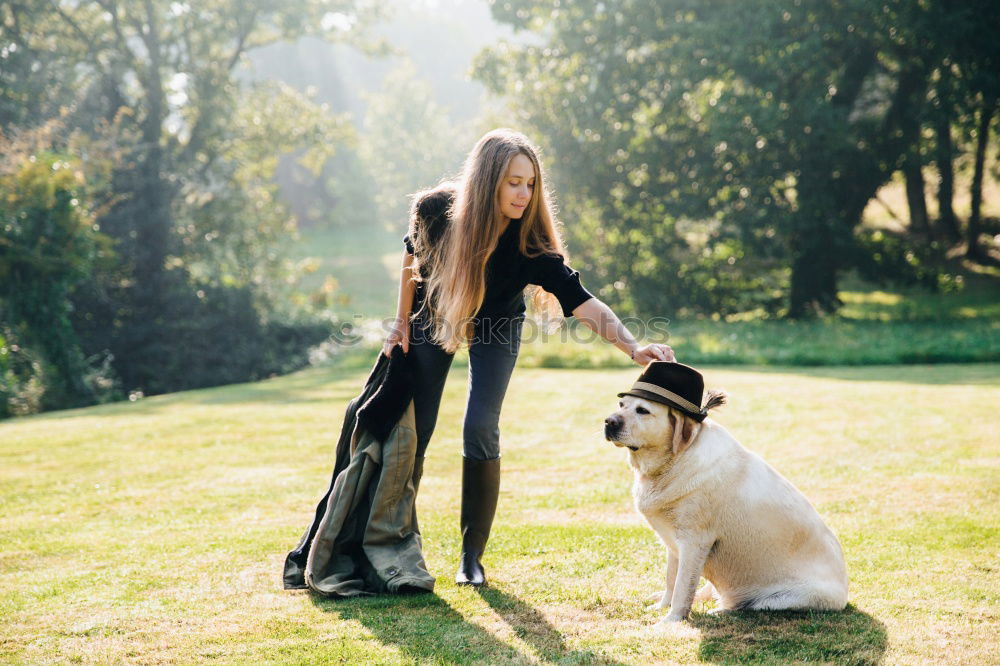 Similar – Image, Stock Photo Portrait of young blond Labrador with young tall beautiful woman with long dark curls in back light forest