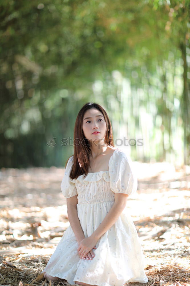 Similar – Redhead woman smelling a flower in a park