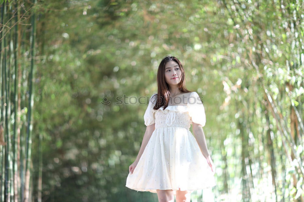 Image, Stock Photo Woman with long brunette waving hair and pink dress dancing barefoot on a large paved square against the light