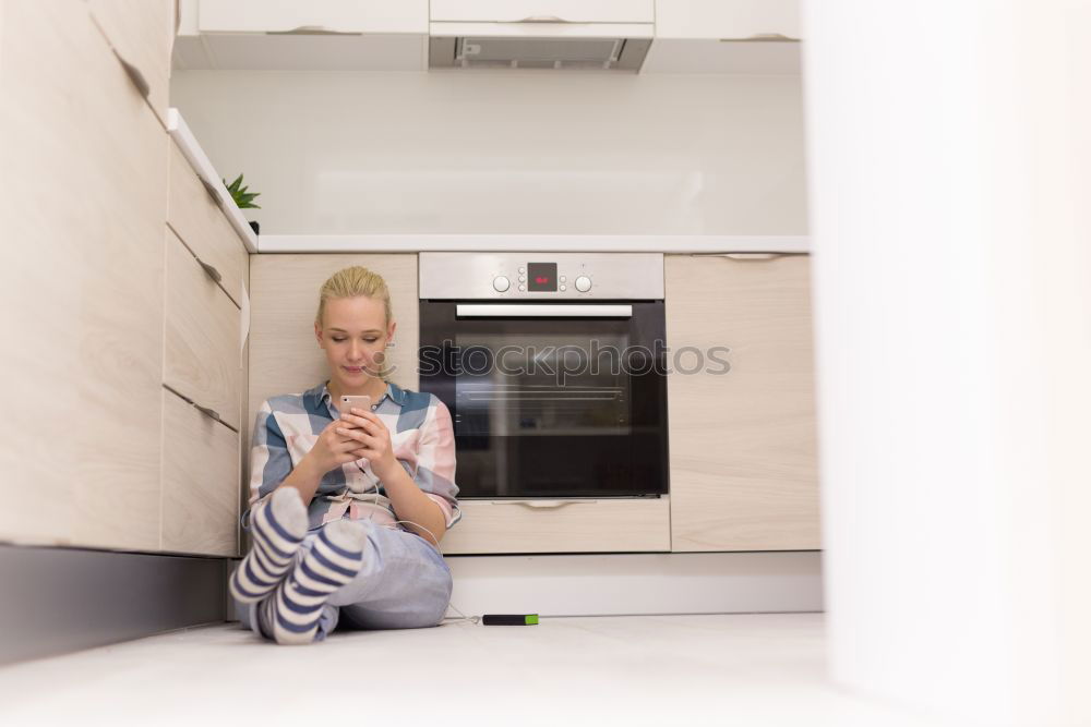 Similar – Woman sitting on kitchen table