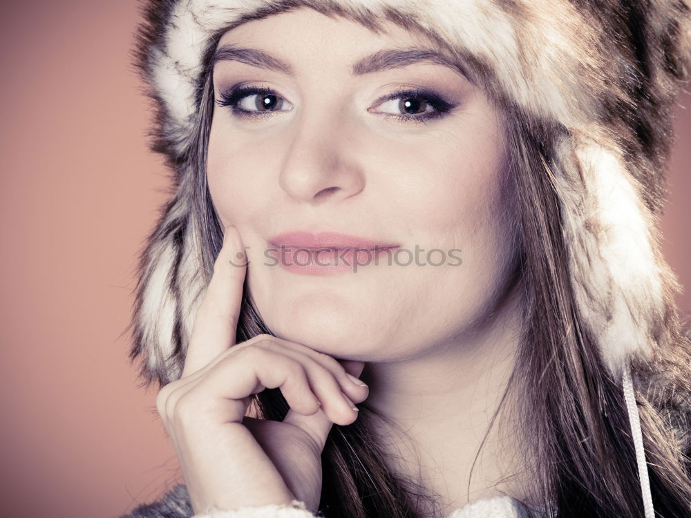 Similar – smiling young woman wearing winter coat with fake fur hood