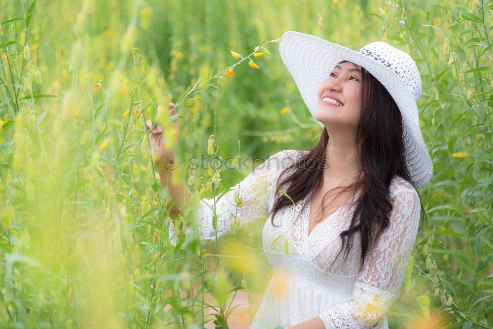 Similar – Image, Stock Photo Beautiful young woman enjoying the warm sun in the nature. Attractive girl is in yellow green meadow full of flowers. With head up and eyes closed she is happy about spring or summer.