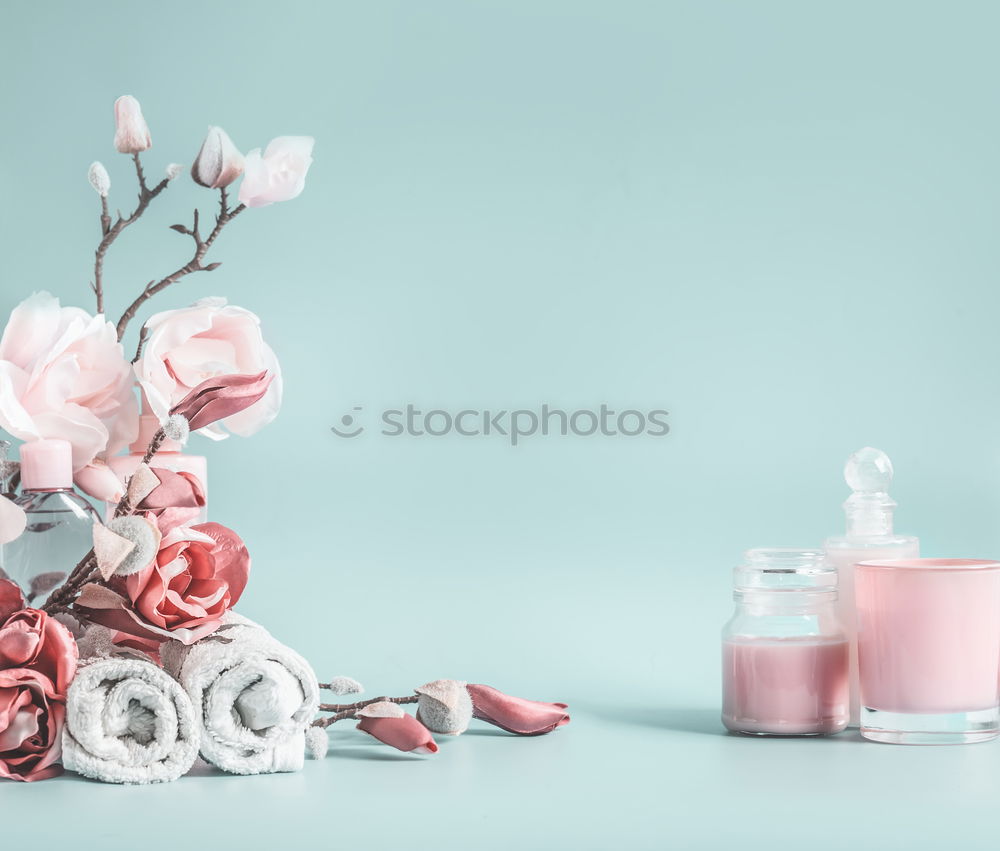 Background with cosmetics, leaves and cherry blossoms