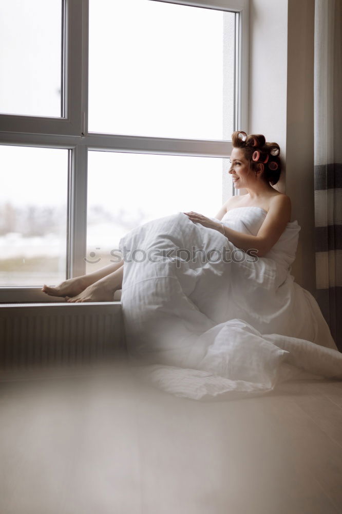 Similar – Young, slim, athletic woman with long legs stands barefoot in her underwear at the window and looks out