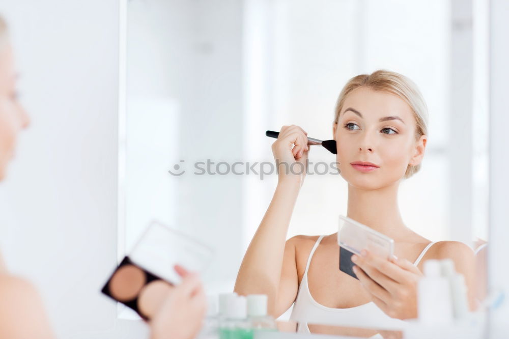 Similar – Young gender fluid person applying makeup at home