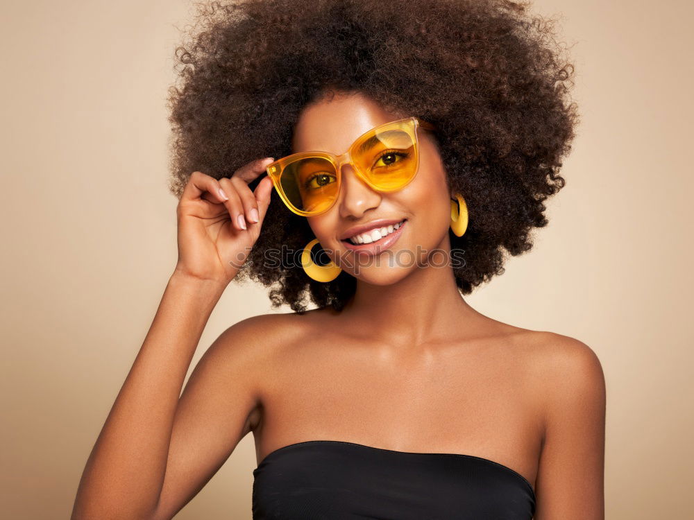 Similar – Image, Stock Photo Young beautiful Afro-American woman posing and smiling while standing against brick wall