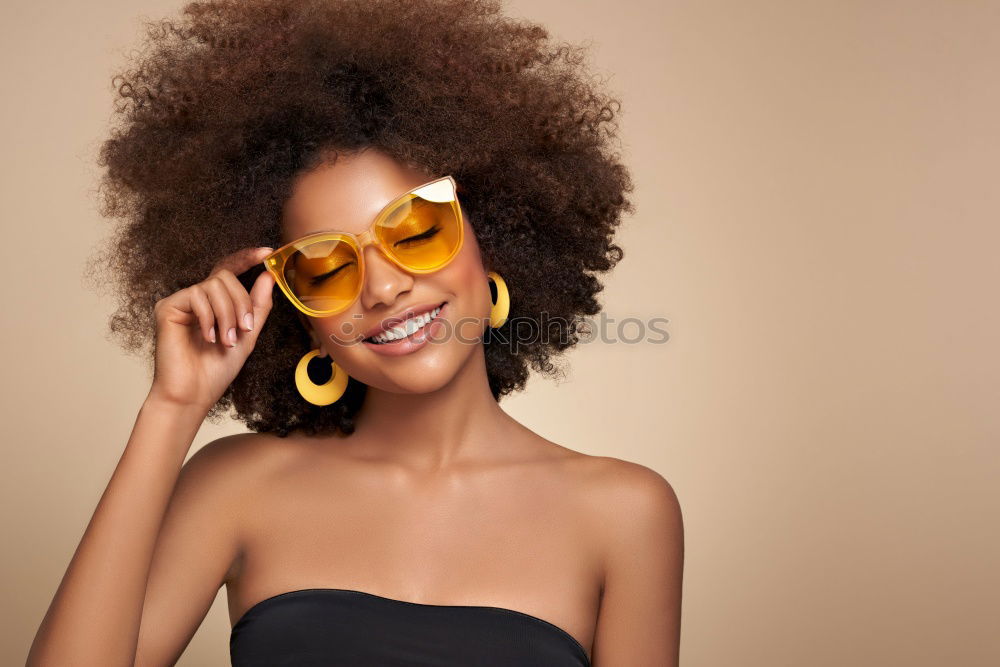 Similar – Image, Stock Photo Young beautiful Afro-American woman posing and smiling while standing against brick wall