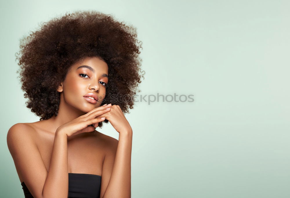 Similar – Image, Stock Photo Young beautiful Afro-American woman posing and smiling while standing against brick wall