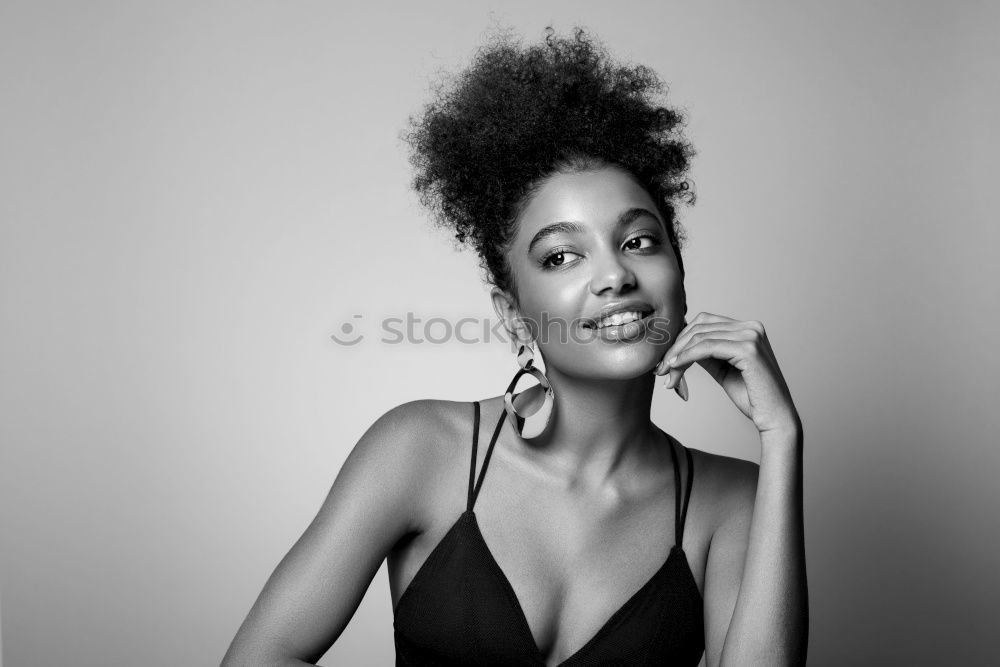 Similar – Happy young black woman sitting surrounded by flowers