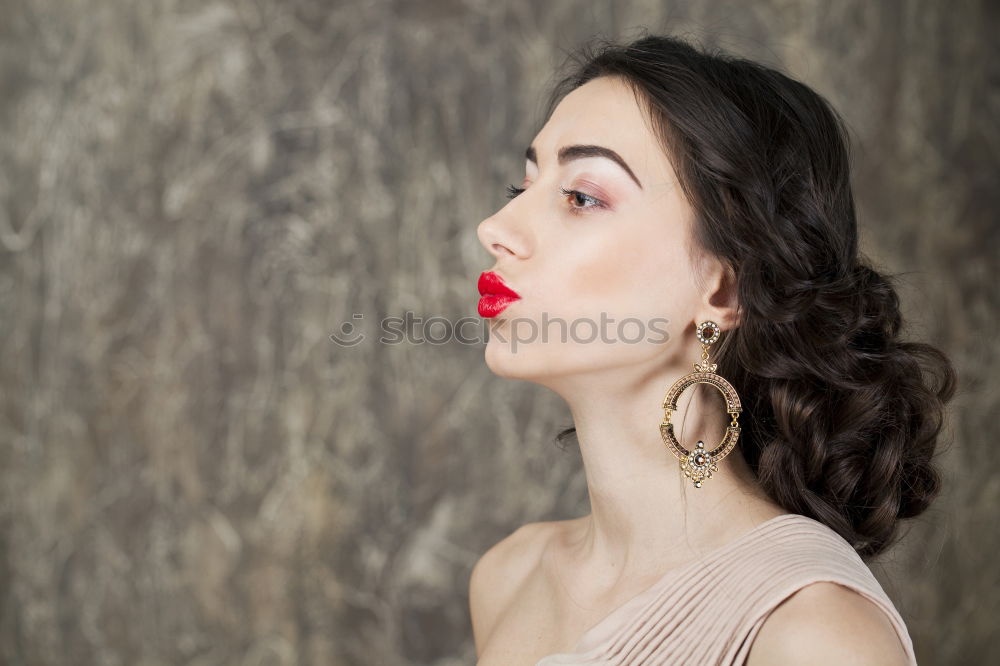 Similar – Young woman with black dress and red bow in her hair. Fashion photography. Autumn / winter fashion. Hair accessory.