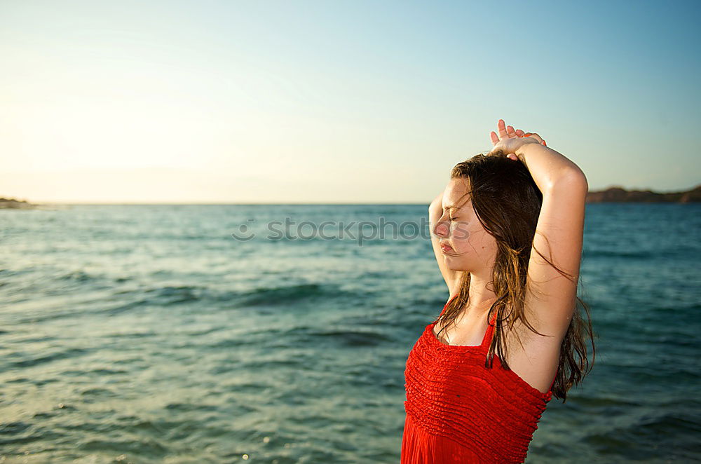 Similar – Woman enjoying the sunset on a beautiful beach