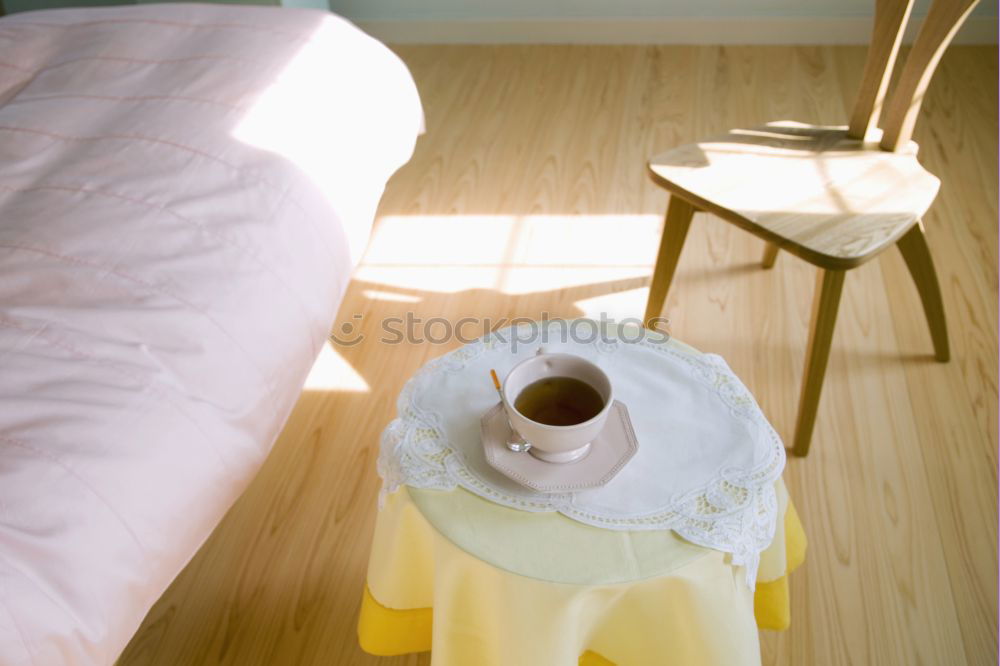 Similar – Image, Stock Photo Bedroom. One set of dentures lies on a tray on the bedside table. A folding alarm clock is included.