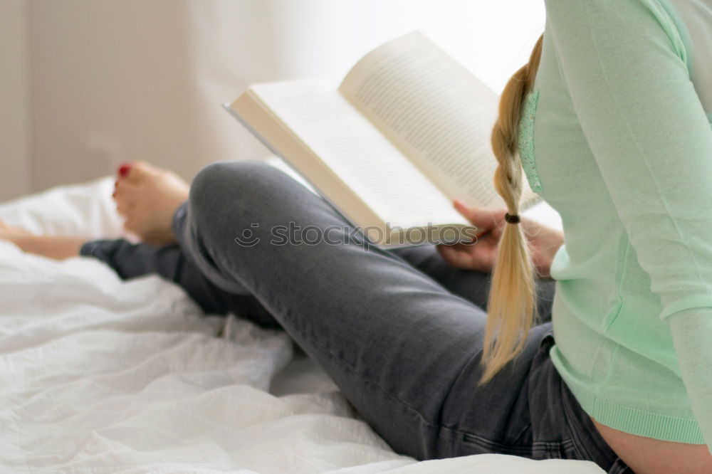 Similar – Young woman reading in her room