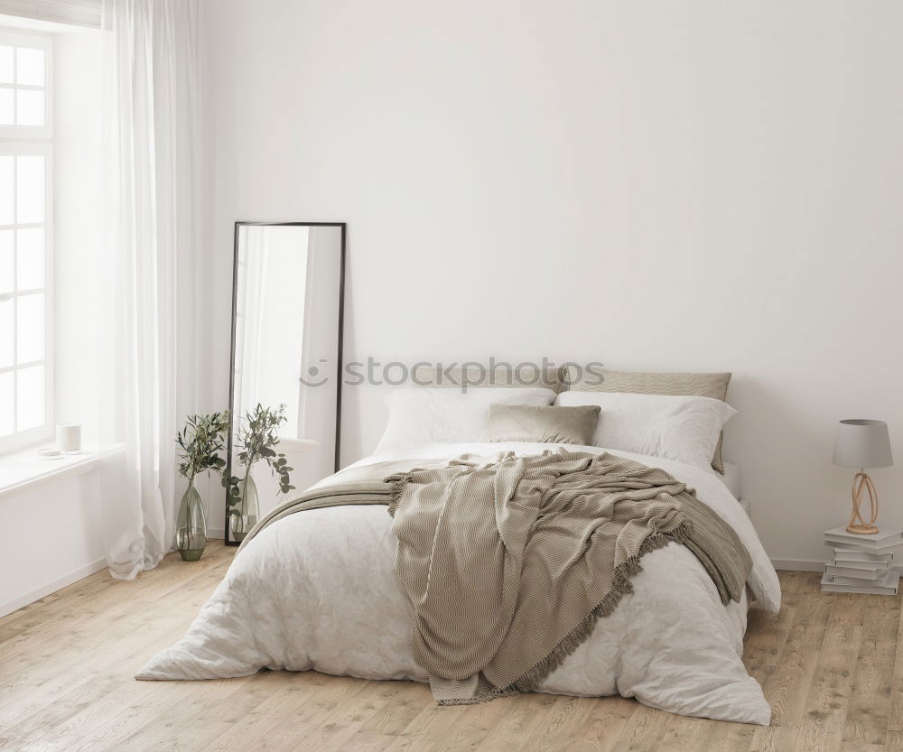 Similar – Ein Doppelbett mit weißer Bettwäsche und beigen Kissen in einem hellen skandinavischen Schlafzimmer, ein Bett auf dem Boden und Blumen in einer Vase