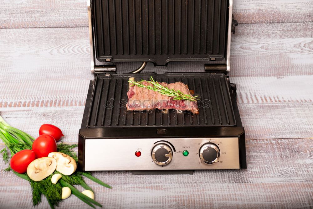 Similar – Man putting steaks into oven