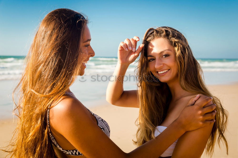 Similar – Tender lesbian couple kissing at sunset