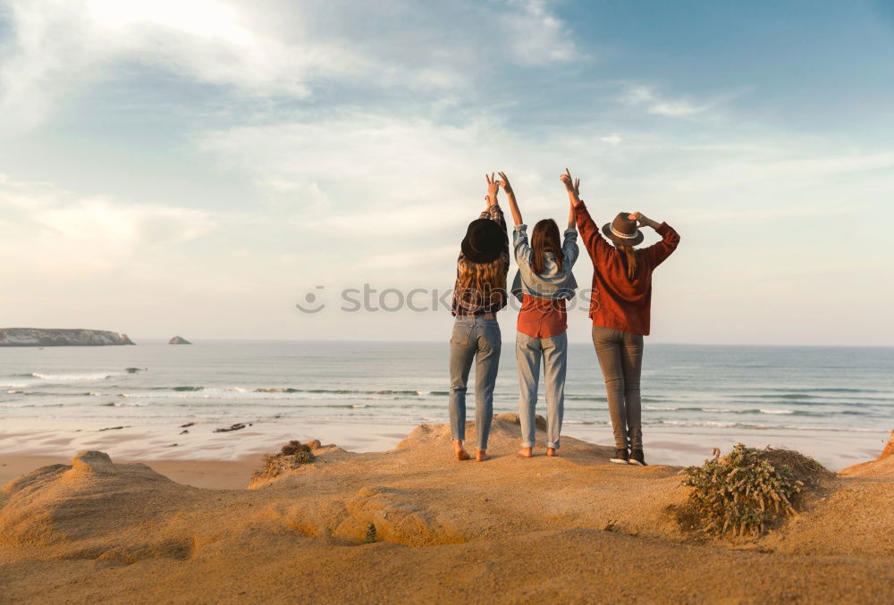 Similar – Image, Stock Photo Women with arms raised standing on the cliff