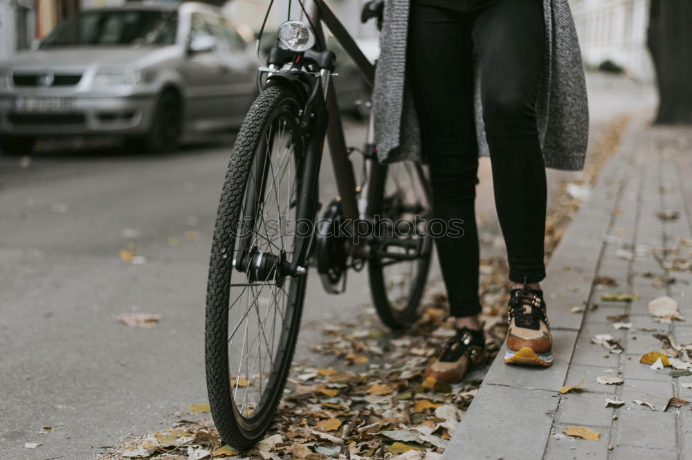 Similar – Young modern hipster riding bike trough urban city while sunset