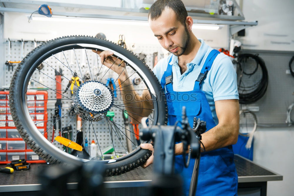 Similar – Professional Mechanic Repairing Car.