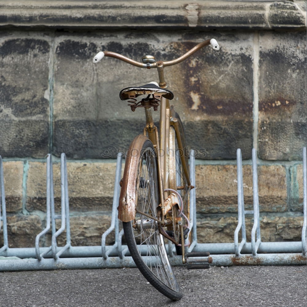 Similar – Rennrad an Fahrradständer vor grauer Wand