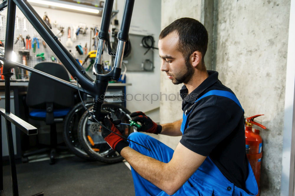 Similar – Man working on bike