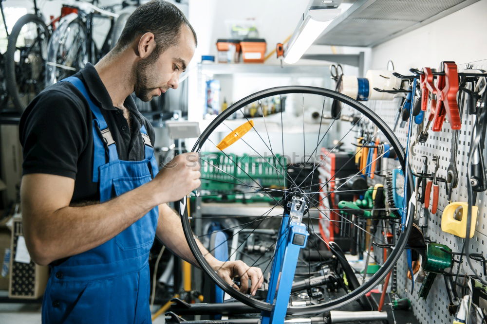 Similar – Professional Mechanic Repairing Car.