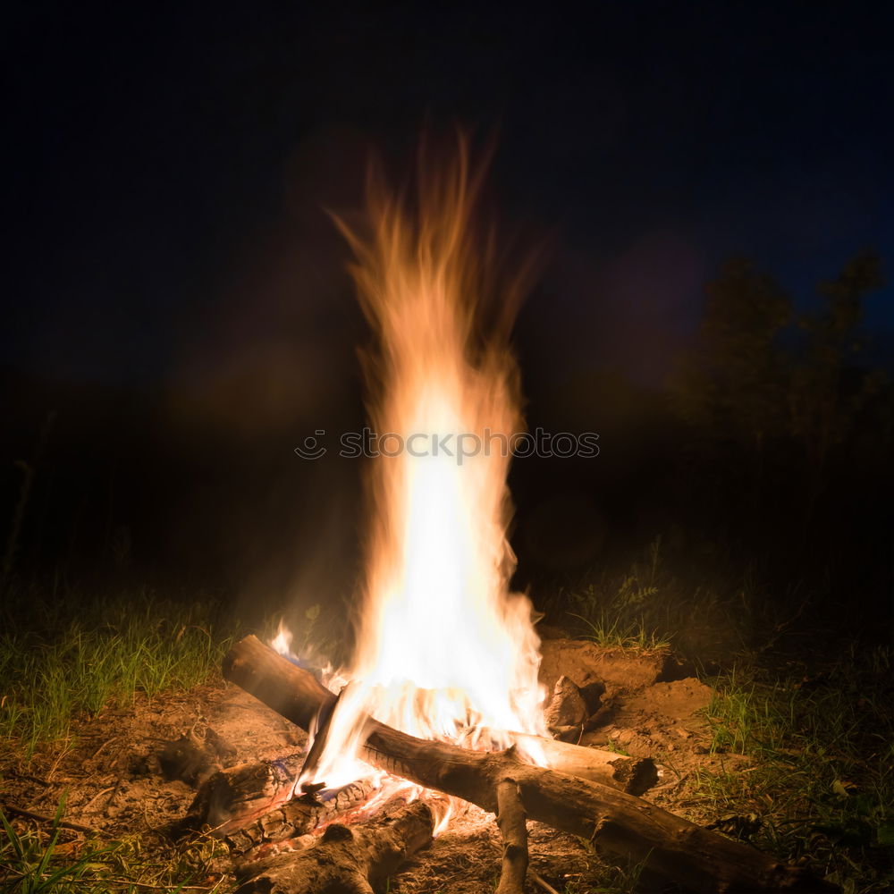 Similar – Man lights a fire in the fireplace in nature at night