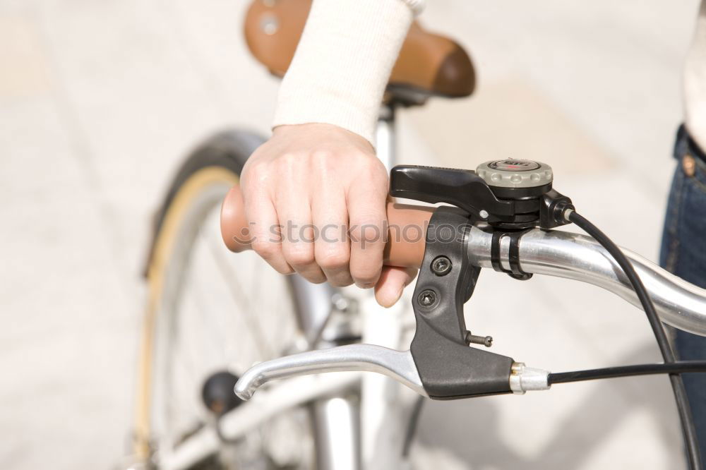 Similar – Image, Stock Photo the gloved man’s hand grabbed the bicycle after the repair at the frame and turned it around with power and momentum