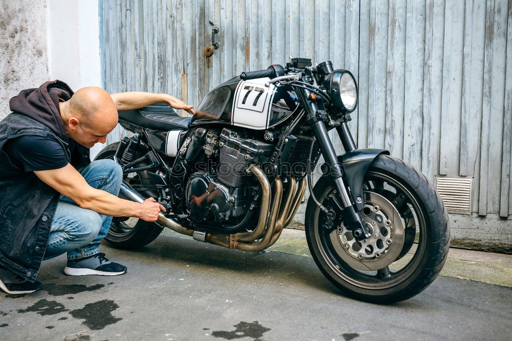 Image, Stock Photo Biker checking with a motorcycle