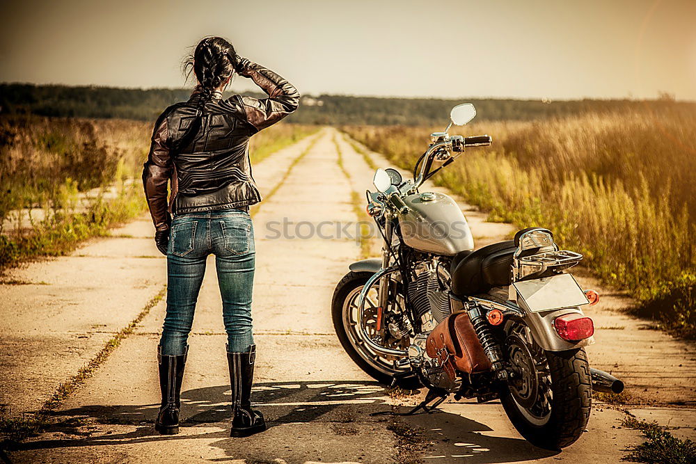 Similar – Man standing near motorcycle