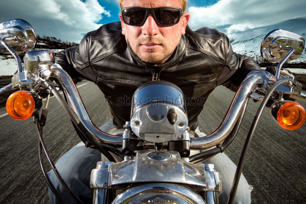 Similar – Long-haired brunette guy in sunglasses jeans and a jeans shirt posing on a black custom motorcycle