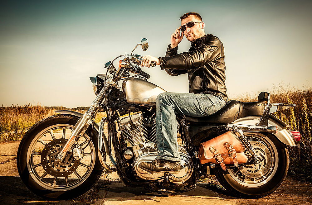 Similar – Long-haired brunette guy in sunglasses jeans and a jeans shirt posing on a black custom motorcycle