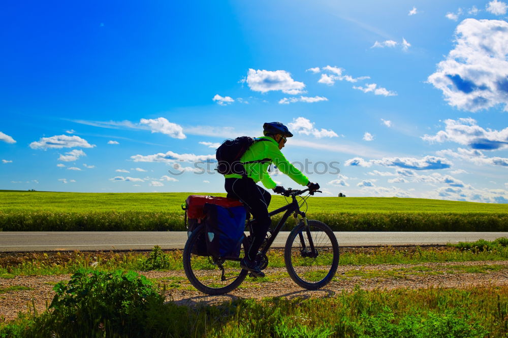 Similar – man with an e-bike looks at a road map