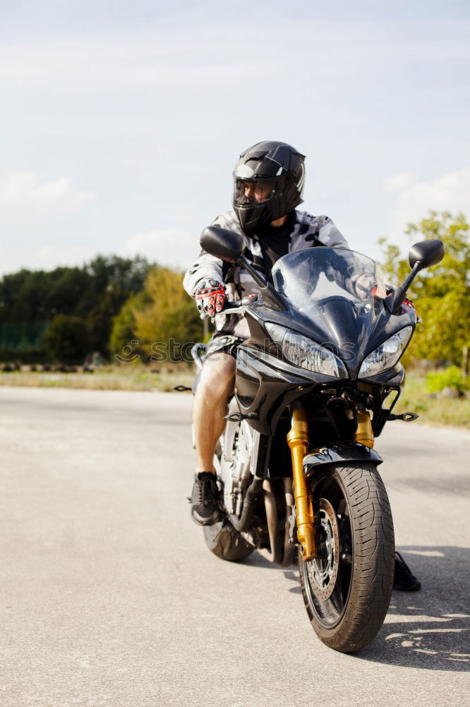 Similar – Man on bike looking away