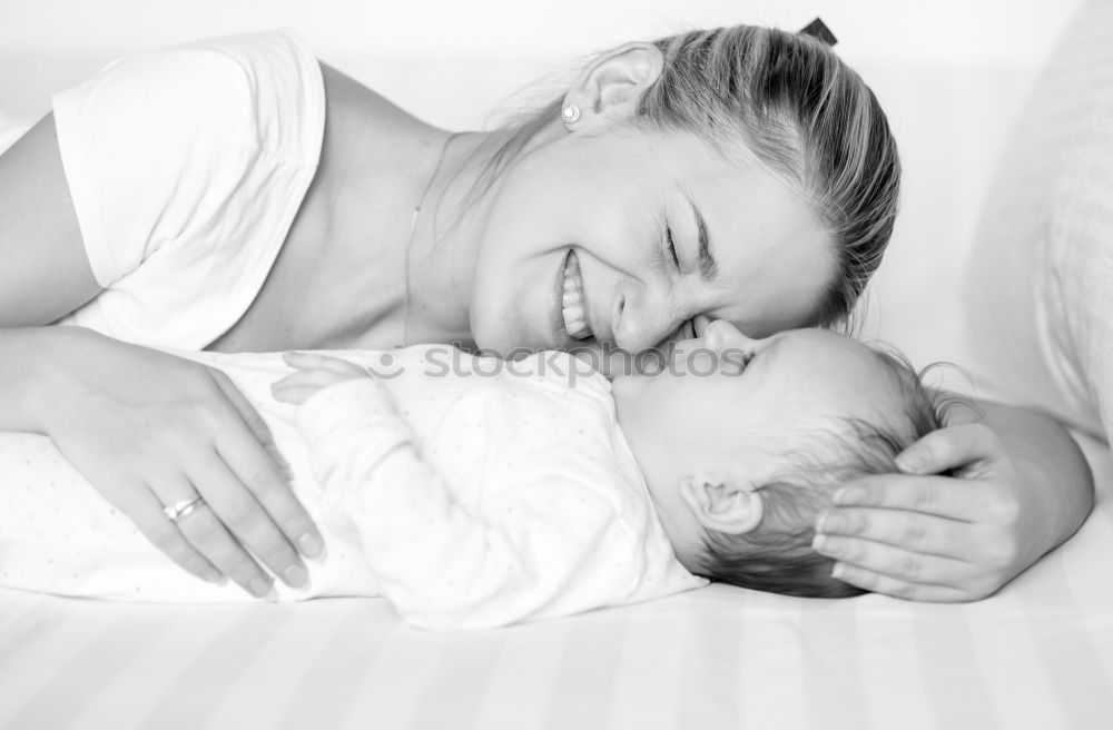 Similar – Woman playing with little happy baby on bed