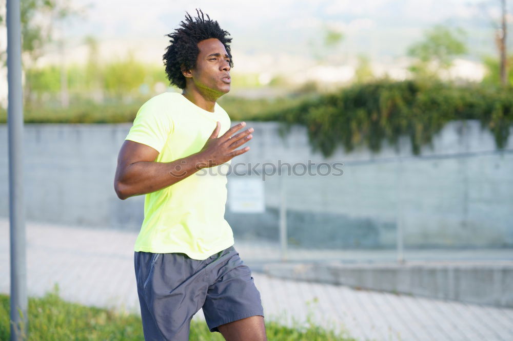 Similar – Black man running and listening to music in urban background