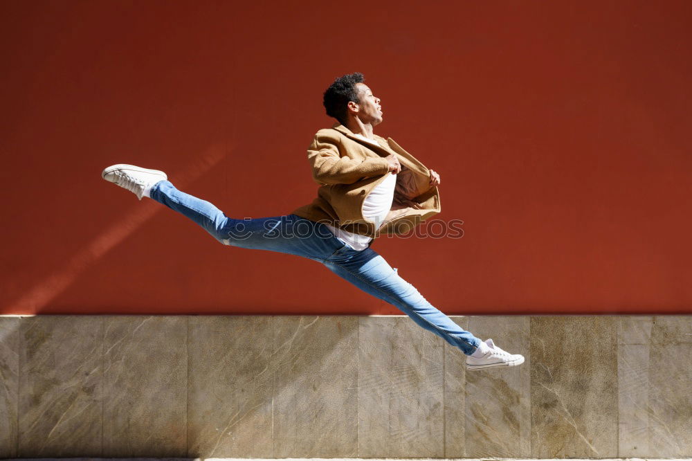 Similar – Image, Stock Photo Young black man wearing casual clothes jumping outdoors